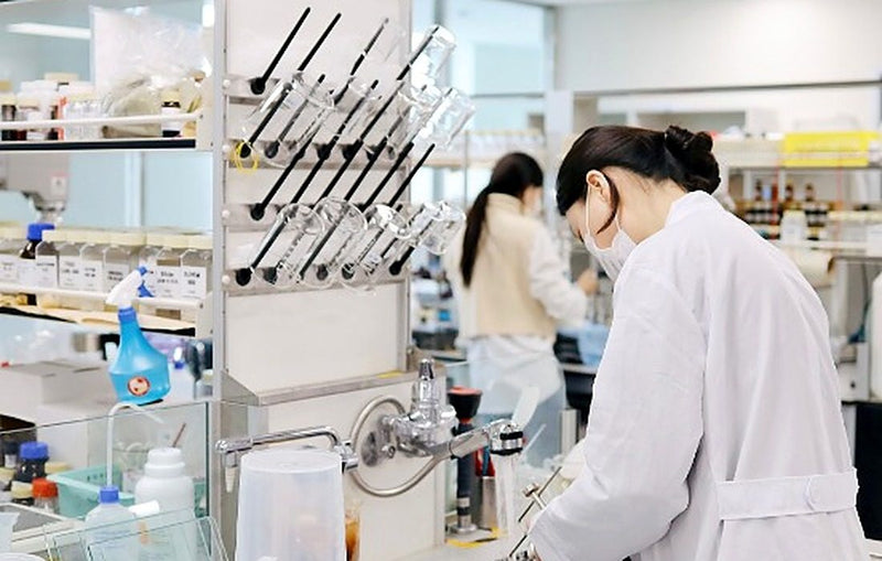 Researcher preparing a formula at a partner factory lab
